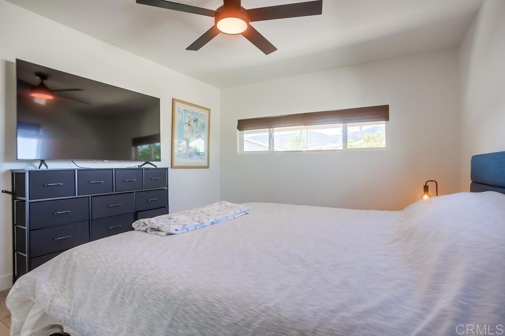 8301 Mission Gorge Road Santee, CA 92071 - Photo 27 of 35 a bedroom with a bed and a flat tv screen on dresser