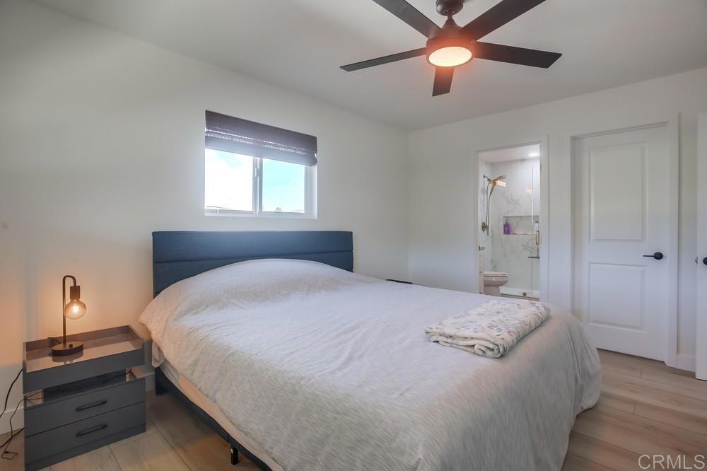 8301 Mission Gorge Road Santee, CA 92071 - Photo 28 of 35 a bedroom with a bed and a chandelier