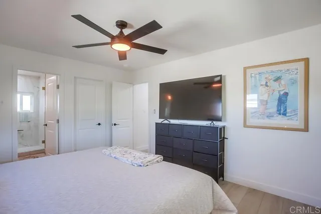 a bedroom with a bed and a flat screen tv