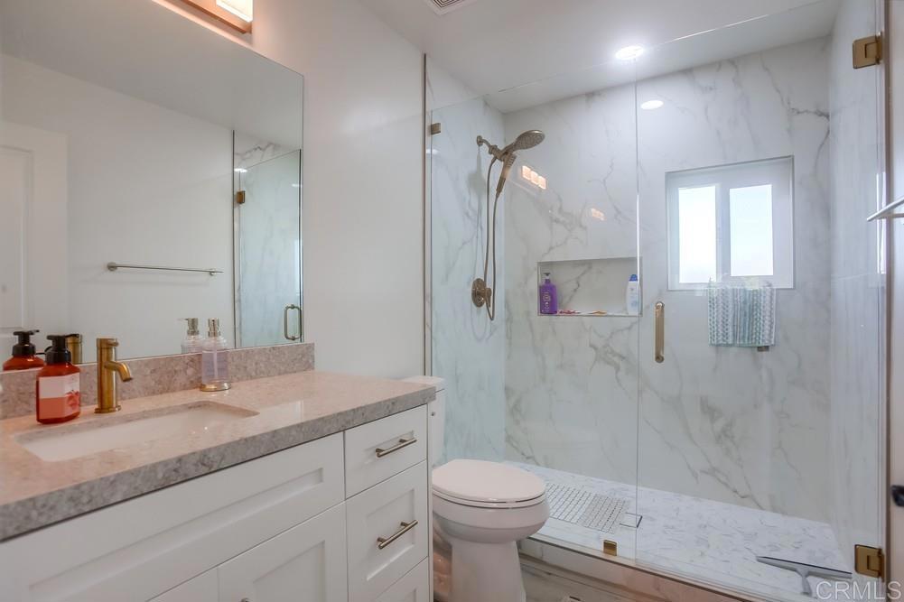 8301 Mission Gorge Road Santee, CA 92071 - Photo 30 of 35 a bathroom with a granite countertop sink toilet and shower