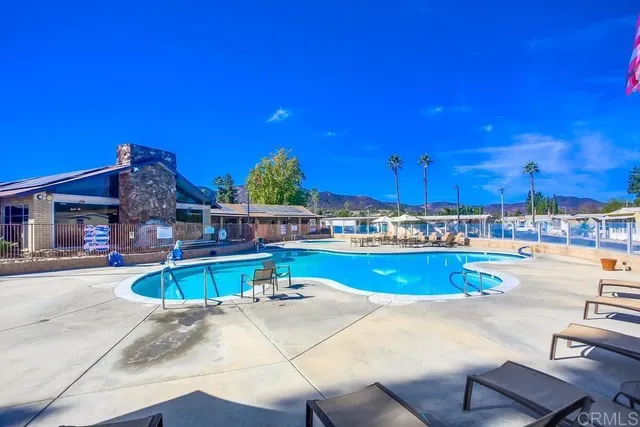 a view of a swimming pool with outdoor seating