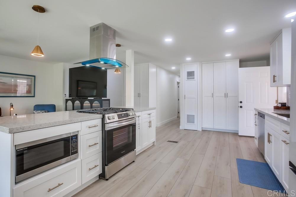 8301 Mission Gorge Road Santee, CA 92071 - Photo 9 of 35 a kitchen with stainless steel appliances a stove a sink and a refrigerator