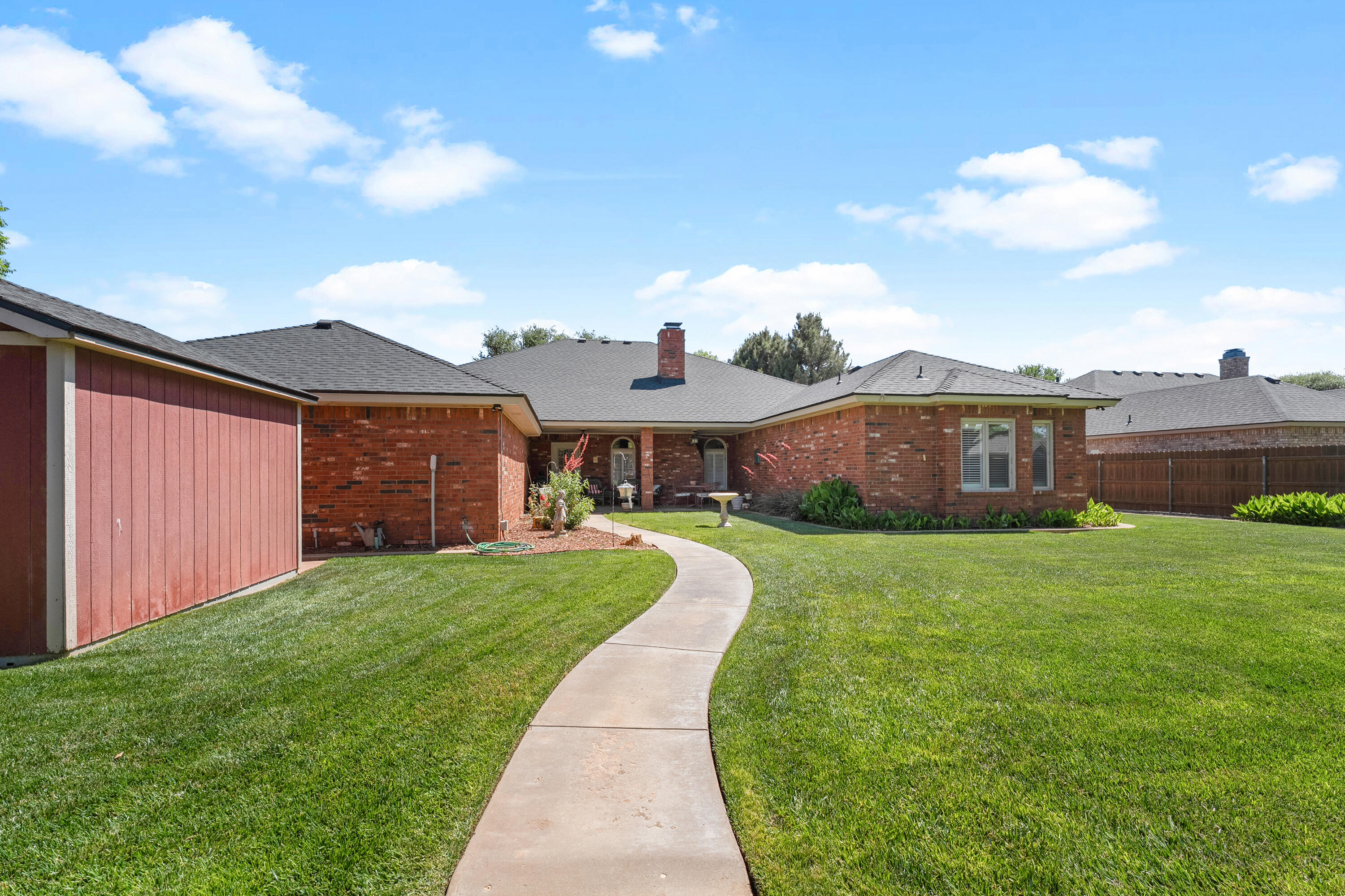 7402 95th Street Lubbock, TX 79424 - Photo 42 of 43 a front view of a house with a yard