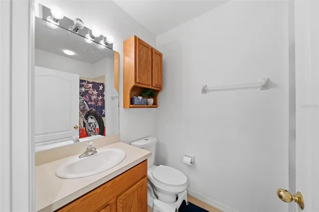 a bathroom with a sink toilet and a mirror