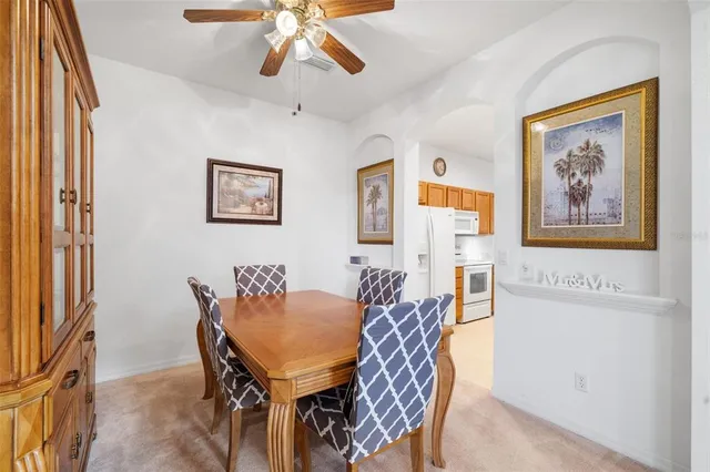a view of a dining room with furniture and a chandelier