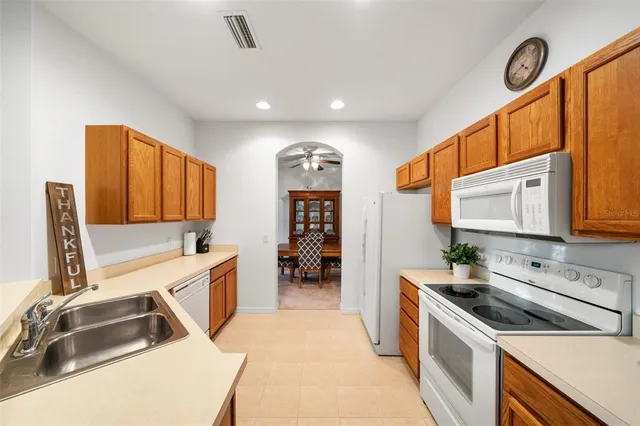 a kitchen that has a sink and a stove in it