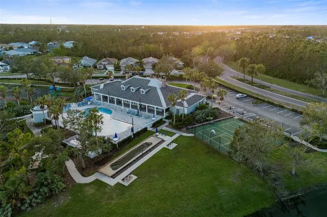 an aerial view of residential houses with outdoor space and parking