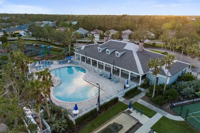 an aerial view of residential houses with outdoor space and parking