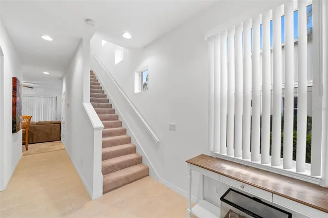 a view of a hallway with entryway and hall with wooden floor