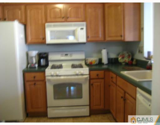 38 Woodbury Road Edison, NJ 08820 - Photo 2 of 10 a kitchen with stainless steel appliances granite countertop a stove and a microwave