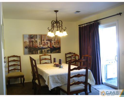 38 Woodbury Road Edison, NJ 08820 - Photo 3 of 10 a view of a dining room with furniture and chandelier