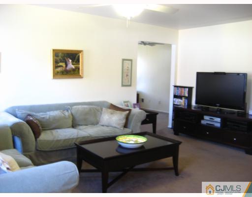 38 Woodbury Road Edison, NJ 08820 - Photo 4 of 10 a living room with furniture and a flat screen tv