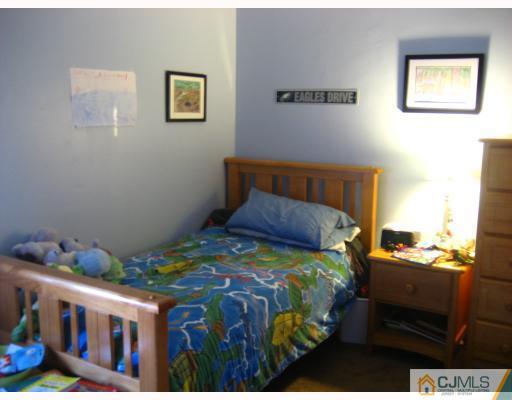 38 Woodbury Road Edison, NJ 08820 - Photo 6 of 10 a bedroom with a bed and a window