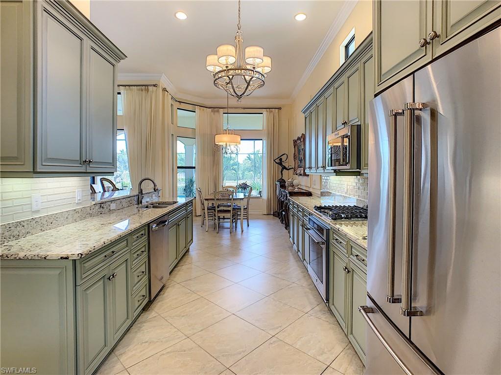 14693 Reserve Lane Naples, FL 34109 - Photo 11 of 34 a large kitchen with stainless steel appliances granite countertop a sink stove and refrigerator