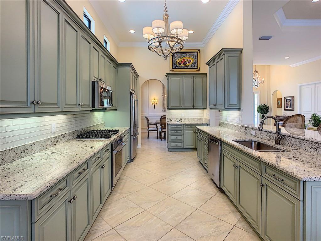14693 Reserve Lane Naples, FL 34109 - Photo 13 of 34 a large kitchen with stainless steel appliances granite countertop a sink and a stove