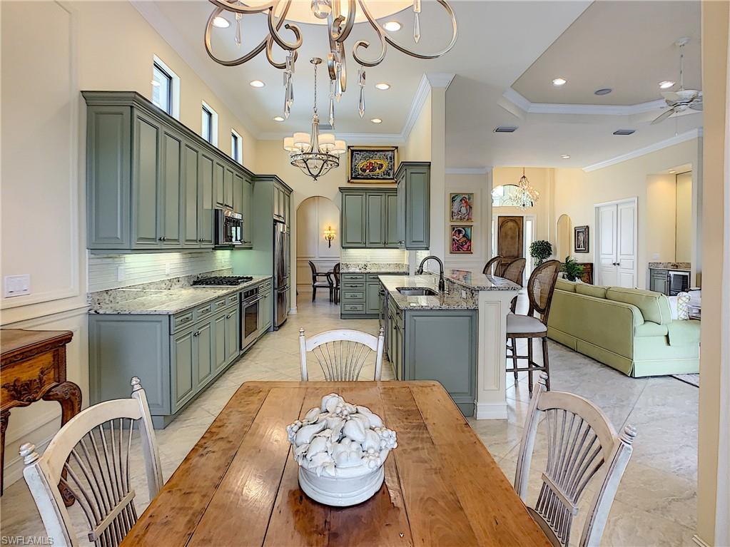 14693 Reserve Lane Naples, FL 34109 - Photo 14 of 34 a large kitchen with a table and chairs