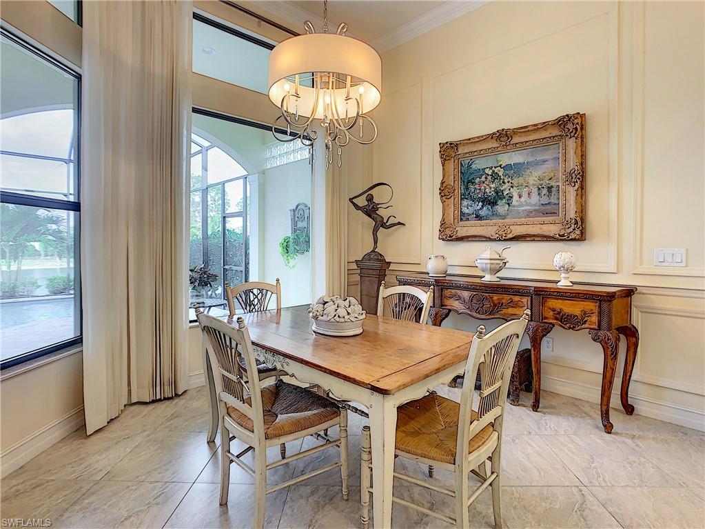 14693 Reserve Lane Naples, FL 34109 - Photo 15 of 34 a view of a dining room with furniture and chandelier