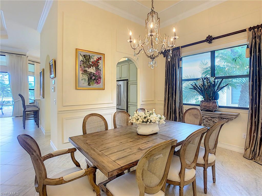 14693 Reserve Lane Naples, FL 34109 - Photo 17 of 34 a dining room with furniture a large window and wooden floor