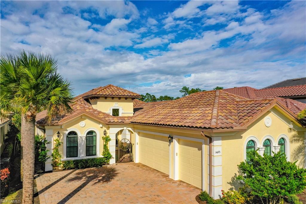 14693 Reserve Lane Naples, FL 34109 - Photo 2 of 34 a front view of a house with a yard