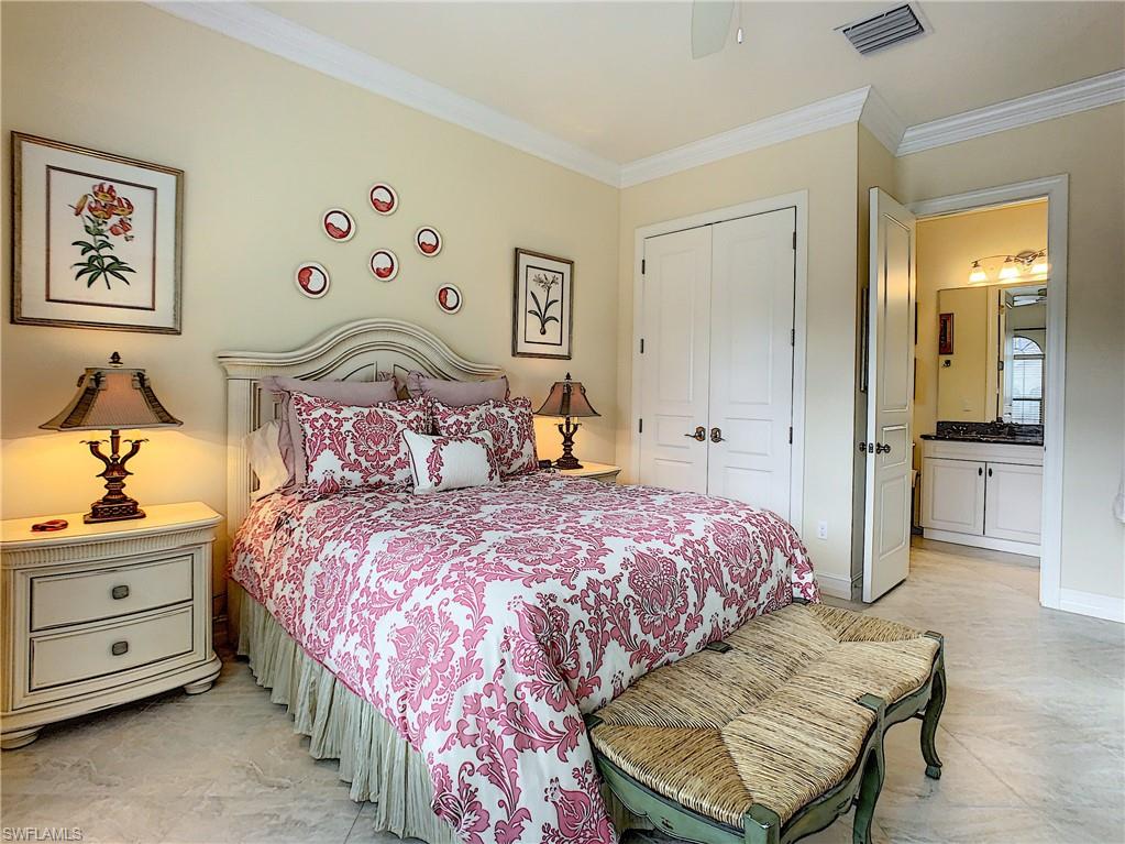 14693 Reserve Lane Naples, FL 34109 - Photo 24 of 34 a bedroom with a bed and a painting on the wall