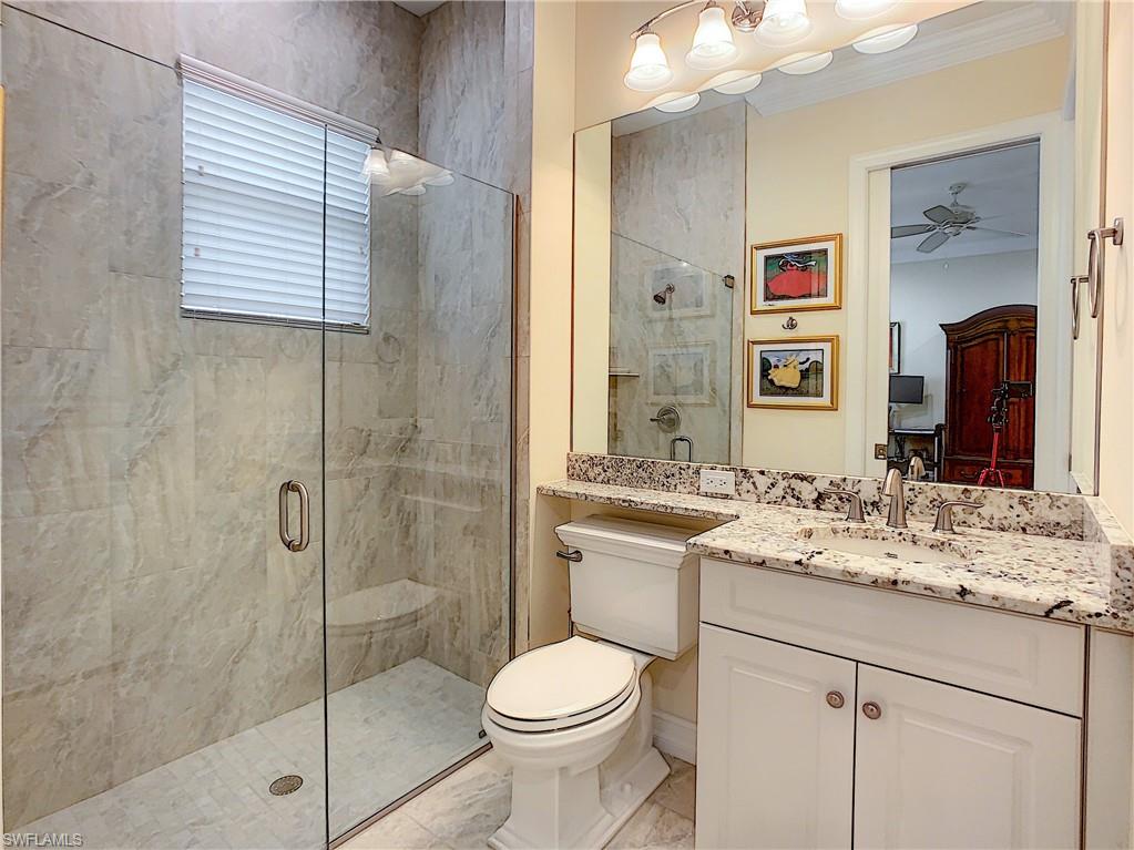 14693 Reserve Lane Naples, FL 34109 - Photo 27 of 34 a bathroom with a sink toilet and shower