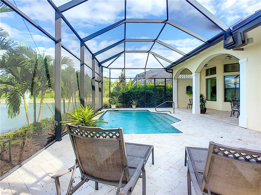 14693 Reserve Lane Naples, FL 34109 - Photo 31 of 34 a view of a chair and table in patio with a barbeque