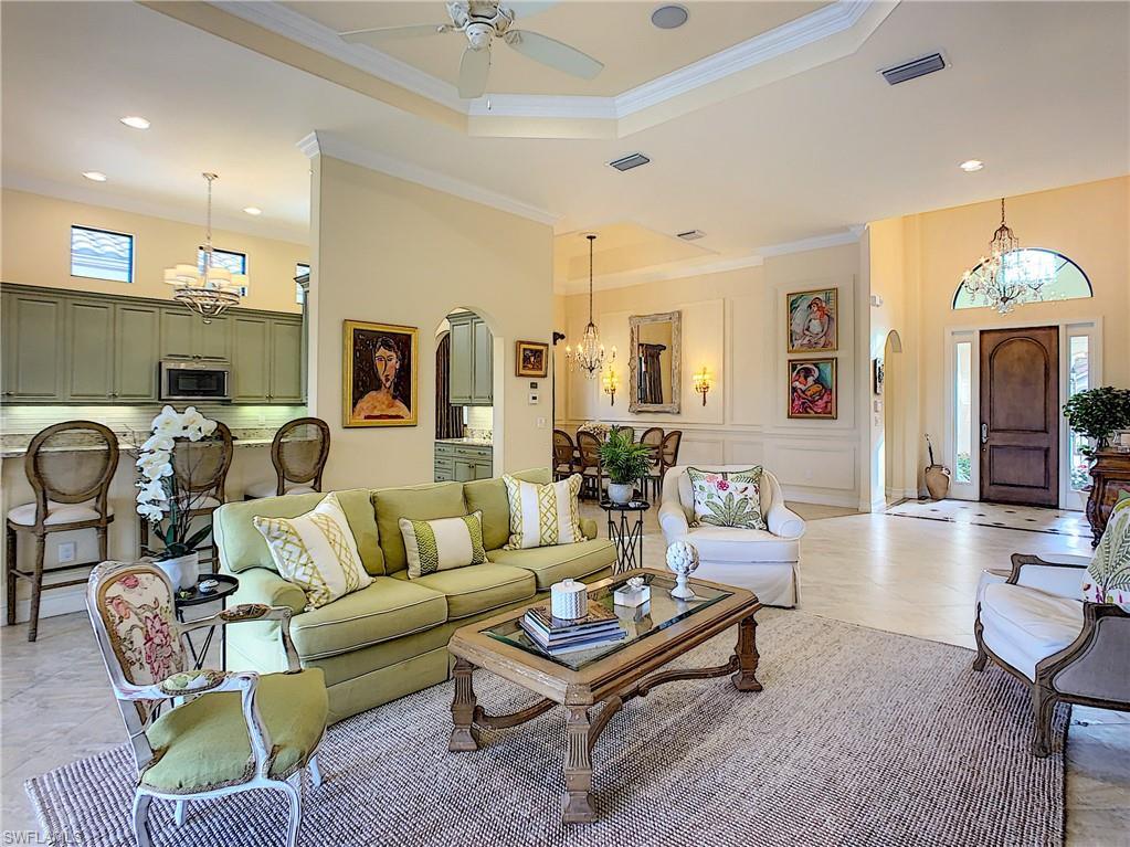 14693 Reserve Lane Naples, FL 34109 - Photo 6 of 34 a living room with furniture a large window and a chandelier