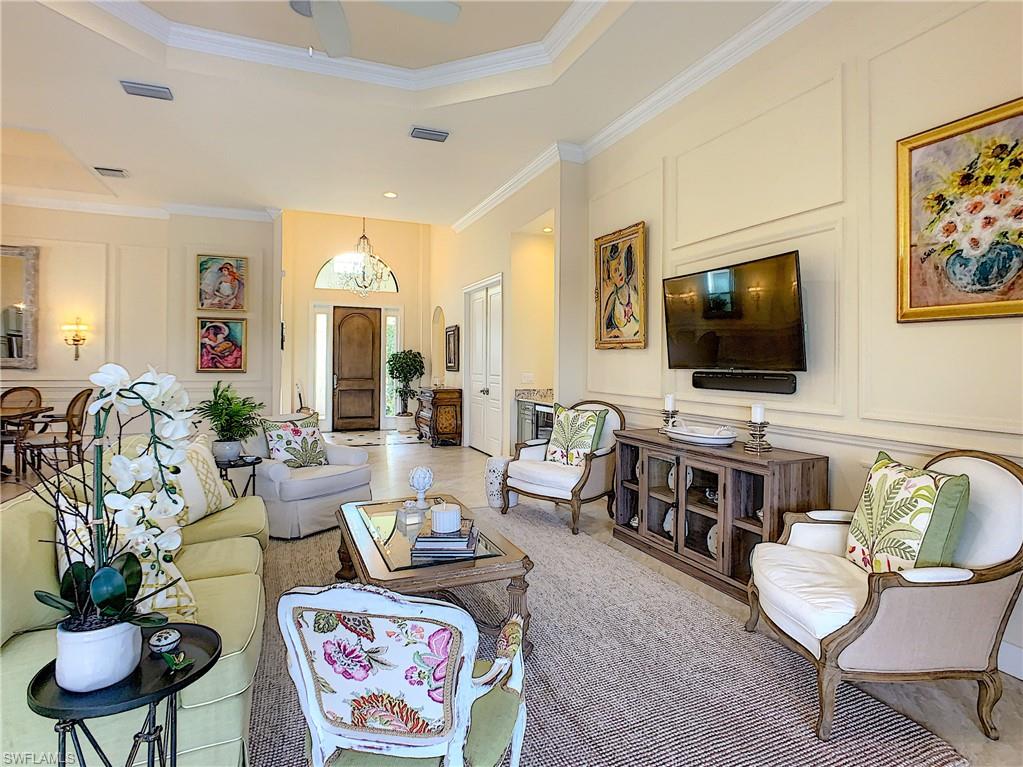 14693 Reserve Lane Naples, FL 34109 - Photo 7 of 34 a living room with furniture and a flat screen tv