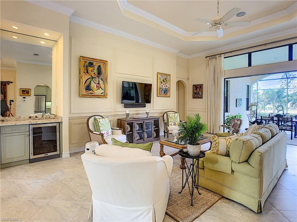 14693 Reserve Lane Naples, FL 34109 - Photo 8 of 34 a living room with fireplace furniture and a flat screen tv