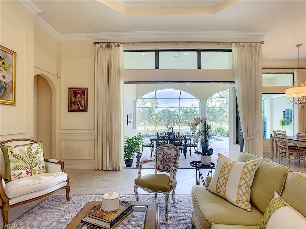 14693 Reserve Lane Naples, FL 34109 - Photo 9 of 34 a living room with furniture and a large window
