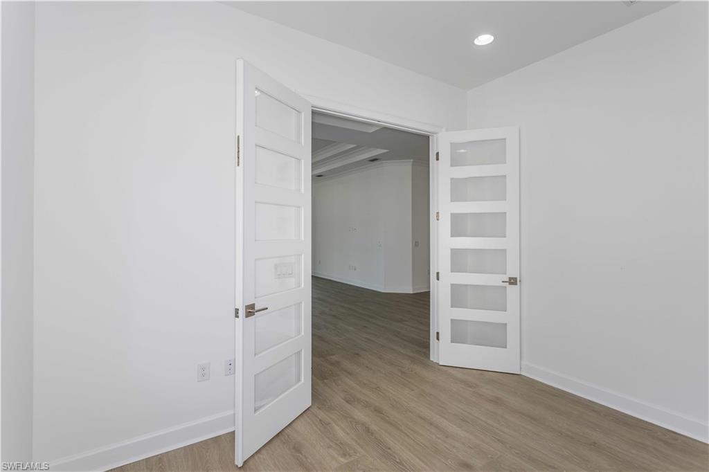 9004 Calypso Court Naples, FL 34113 - Photo 14 of 44 an empty room with wooden floor & closet area