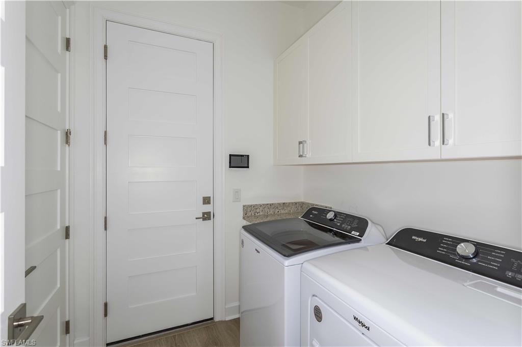 9004 Calypso Court Naples, FL 34113 - Photo 19 of 44 a view of storage and utility room with washer and dryer