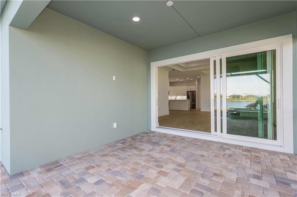 9004 Calypso Court Naples, FL 34113 - Photo 24 of 44 a view of a big room with a chandelier fan and windows