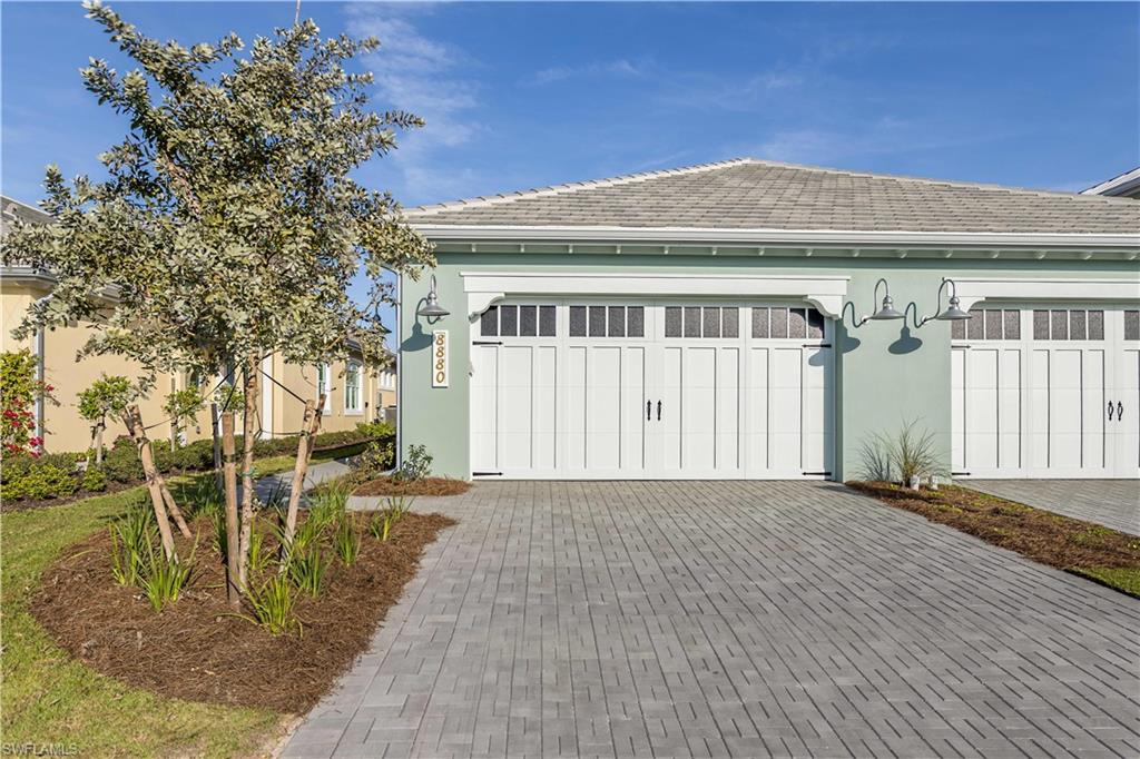 9004 Calypso Court Naples, FL 34113 - Photo 26 of 44 a front view of a house with a yard