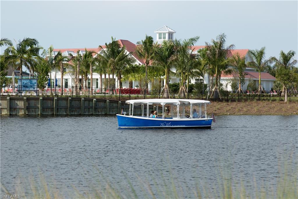9004 Calypso Court Naples, FL 34113 - Photo 32 of 44 a swimming pool with outdoor seating and yard