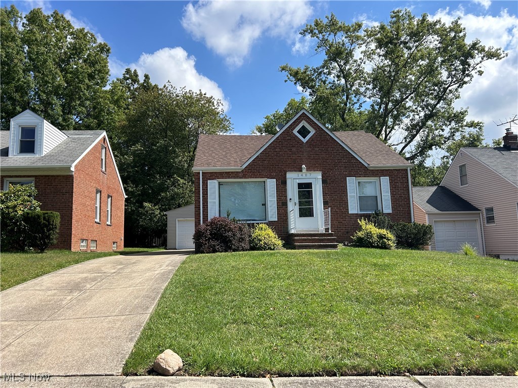 View of front facade with a front yard and a garage