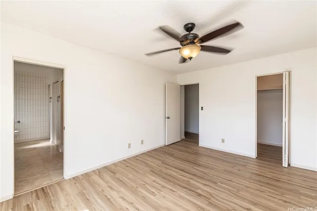 a view of a livingroom with a ceiling fan and wooden floor