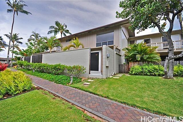 404 Koko Isle Circle, Unit 1802 Honolulu, HI 96825 - Photo 2 of 18 a front view of a house with a yard and a garden