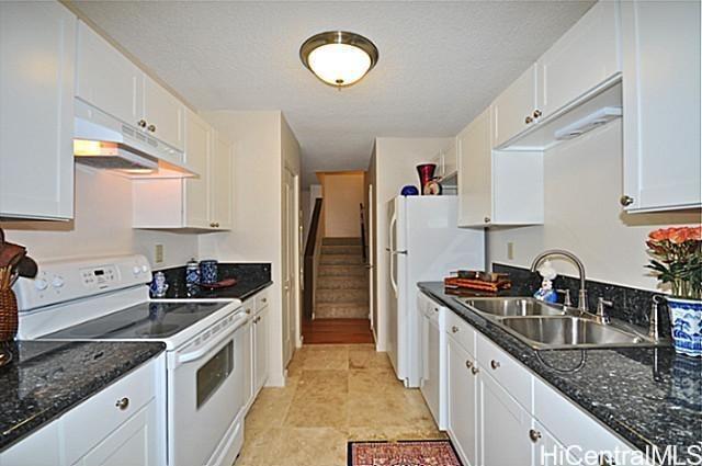 404 Koko Isle Circle, Unit 1802 Honolulu, HI 96825 - Photo 4 of 18 a kitchen with a sink stove and refrigerator