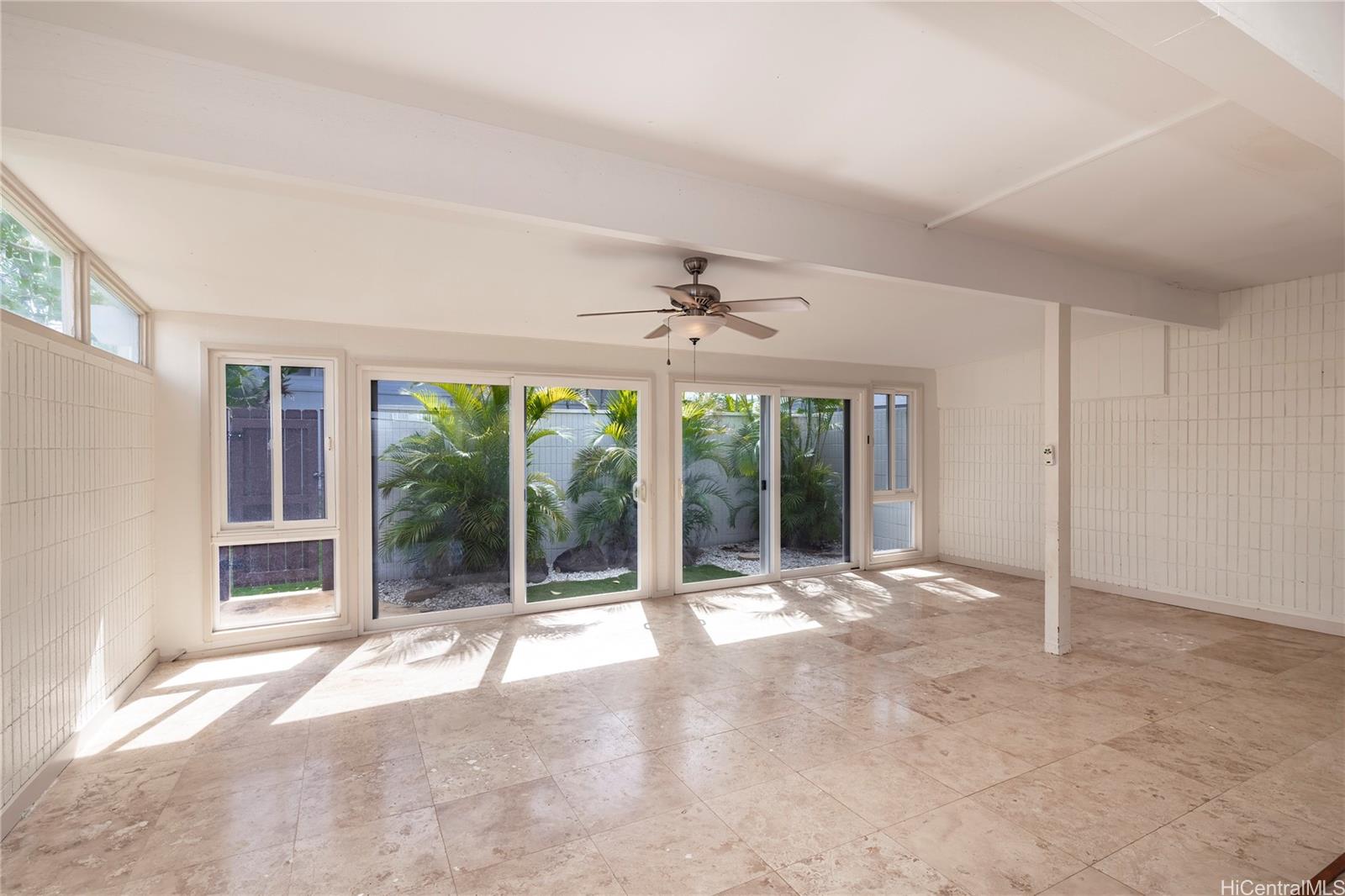 404 Koko Isle Circle, Unit 1802 Honolulu, HI 96825 - Photo 5 of 18 a view of an empty room with glass door and balcony