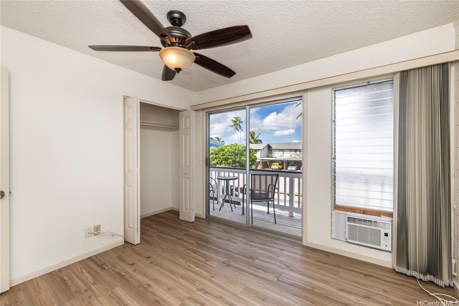 404 Koko Isle Circle, Unit 1802 Honolulu, HI 96825 - Photo 8 of 18 a view of empty room with wooden floor and fan