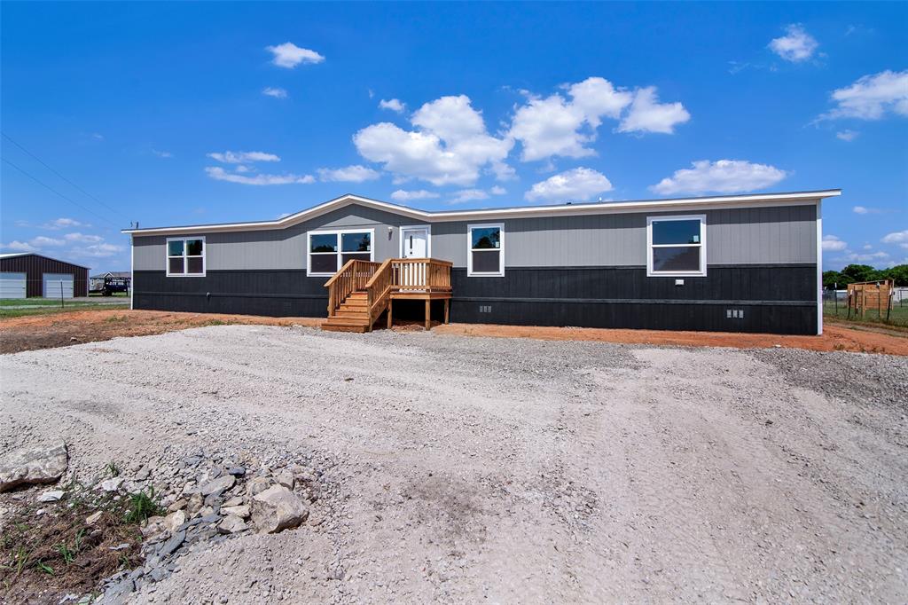 1221 County Road 4045 Ector, TX 75439 - Photo 1 of 1 a front view of a house with a yard and garage