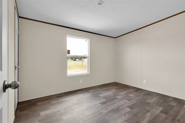 an empty room with a empty space and windows