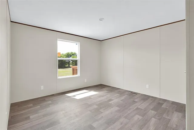 an empty room with a empty space and windows