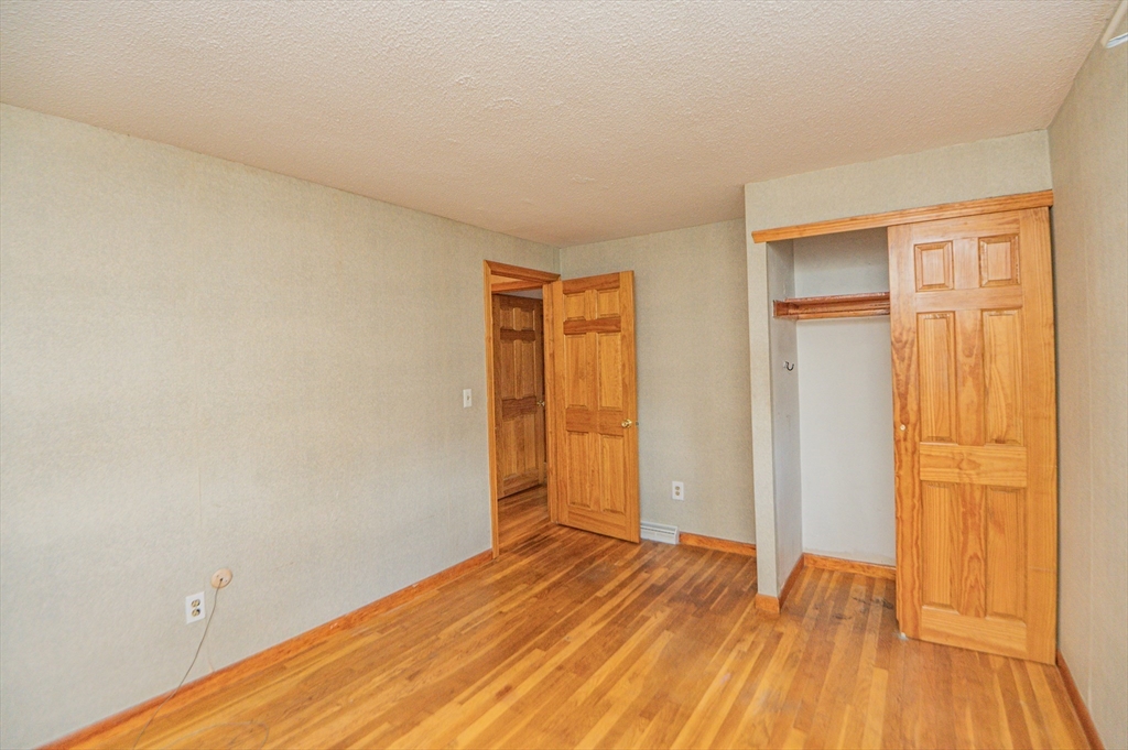16 Freddy Road Billerica, MA 01821 - Photo 16 of 27 a view of empty room with wooden floor