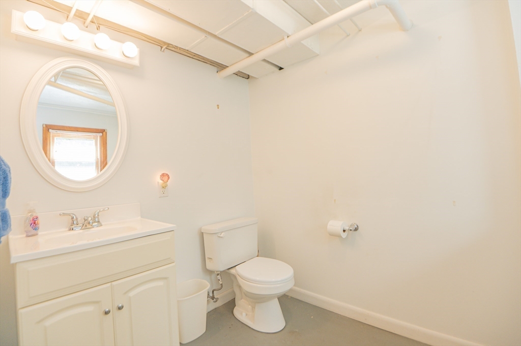 16 Freddy Road Billerica, MA 01821 - Photo 21 of 27 a bathroom with a toilet sink vanity and mirror