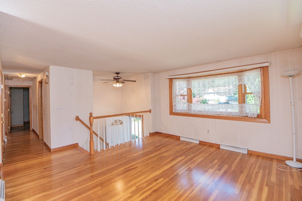 16 Freddy Road Billerica, MA 01821 - Photo 7 of 27 a view of an empty room with wooden floor and a window