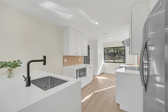 a kitchen with a refrigerator and a sink