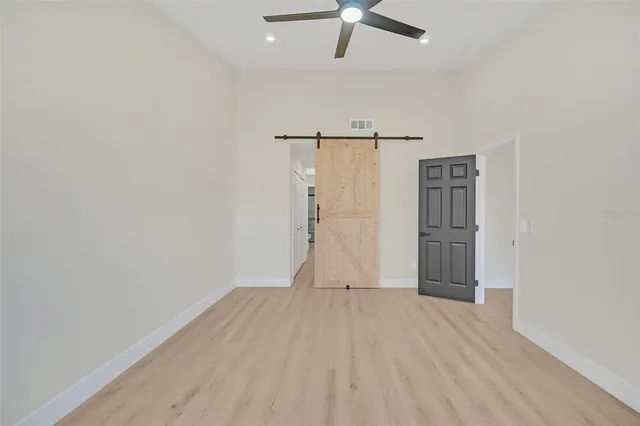 a view of empty room with wooden floor