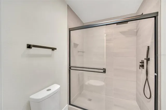 a bathroom with a glass shower door